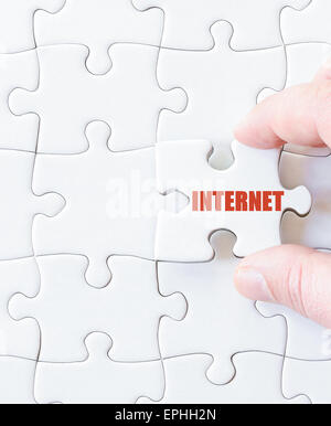 Missing jigsaw puzzle piece with word  INTERNET. Business concept image for completing the puzzle. Stock Photo