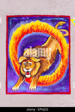 Wall art of circus lion jumping through a circle of fire Stock Photo