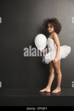 Conceptual picture of a little ballet dancer with a white balloon