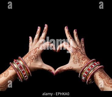 Woman hands with henna doing heart gesture isolated on black background with clipping path Stock Photo