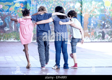 Happy classroom playing at school. Multi ethnic children, back view. Stock Photo