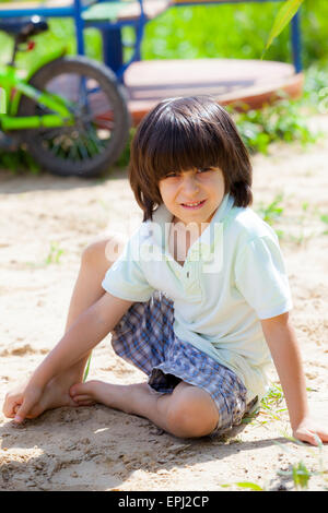 boy sitting on the sand Stock Photo