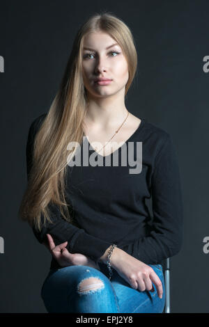 Spiritual and mental studio portrait of the Russian beautiful teenage girl with light long hair Stock Photo