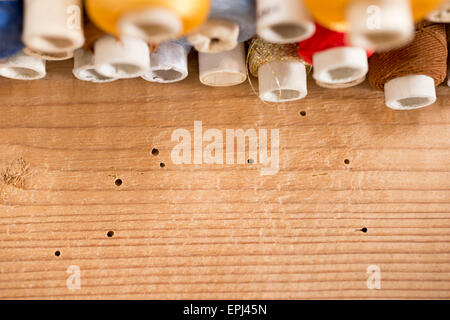 colored threads on the old  wooden table Stock Photo