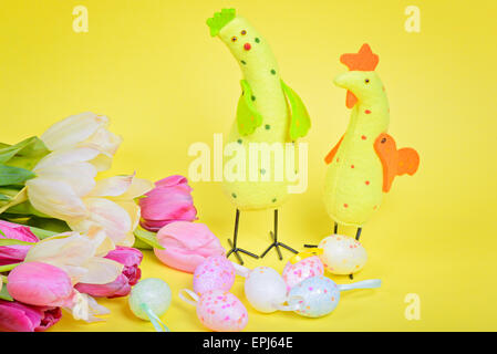 Easter chickens, pink tulips and eggs Stock Photo