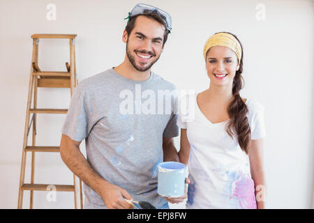 Cute couple redecorating living room Stock Photo