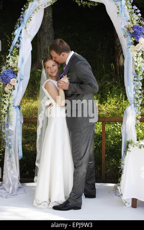 A romantic newly married couple in the garden, romance wedding day, no