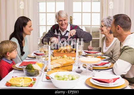 Grandfather carving chicken during christmas dinner Stock Photo - Alamy