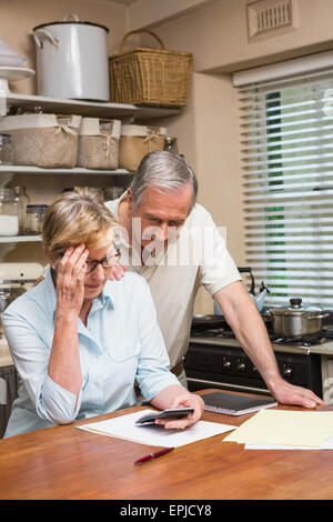 Senior couple working out their bills Stock Photo