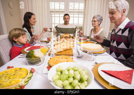 Extended family saying grace before christmas dinner Stock Photo