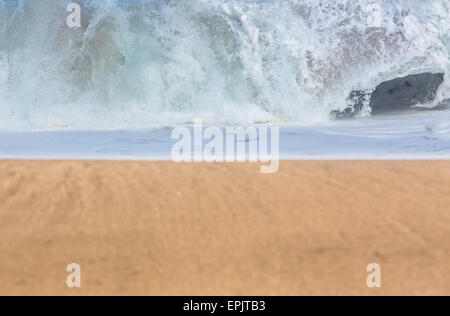 Sandy beach with waves in the distance Stock Photo