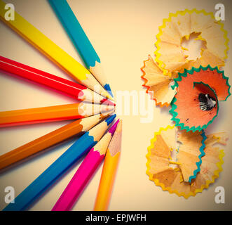 seven colored pencils and shavings Stock Photo