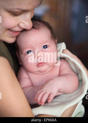 One month old baby boy in the arms of her mother Stock Photo