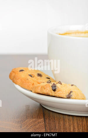 Half cup of coffee with cookies on table Stock Photo