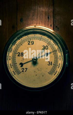 Old barometer weathered and distressed by time. Stock Photo