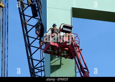 Two Worker installing a metal bridgehead in a harbor Stock Photo