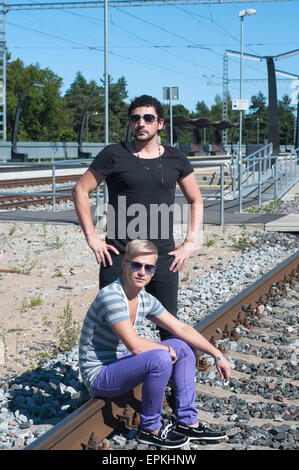 Two attractive young guys on rails Stock Photo