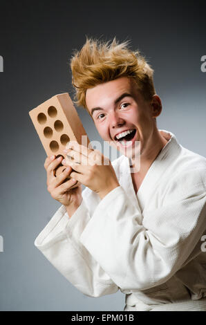 Funny karate fighter with clay brick Stock Photo