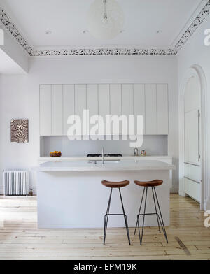 Breakfast bar and stools in white kitchen, Chelsea Townhouse, New York, USA Stock Photo