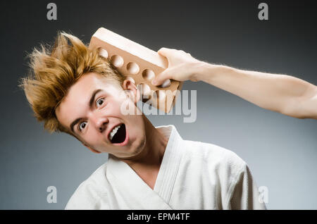 Funny karate fighter with clay brick Stock Photo