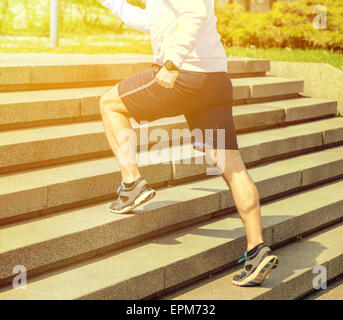 Practice - Close up of young man running up the stairs Stock Photo