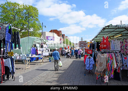Traders clothing stalls & summer shoppers in Romford market Havering East London England UK previously in Essex Stock Photo