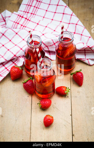 Three glass bottles of homemade strawberry lemonade Stock Photo