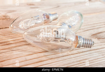 Three light bulbs, on wooden background Stock Photo