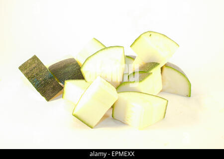 A pile of zucchini cubes, isolated on white background Stock Photo