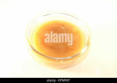 A glass full of yellow honey, isolated on white background Stock Photo