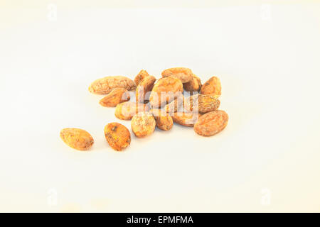 A pile of brown cocoa beans, isolated on white background Stock Photo