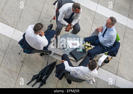 Group of businessman sitting around table having meeting at the Sky Garden at the top of the Walkie Talkie building, London Stock Photo