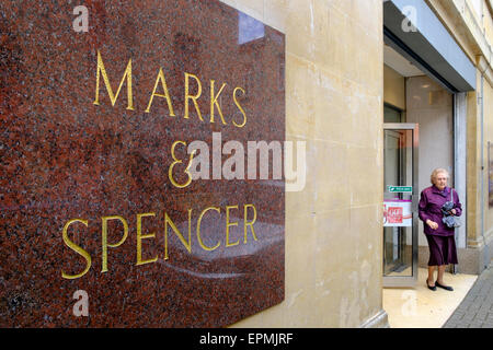 Bath, UK, 19th May, 2015. A woman is pictured leaving a Marks & Spencer store in Bath on the day before the Marks & Spencer Group announces it's full year results. Credit:  lynchpics/Alamy Live News Stock Photo