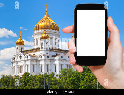 travel concept - tourist photograph Cathedral of Christ the Saviour, Moscow, Russia on smartphone with cut out screen with blank Stock Photo