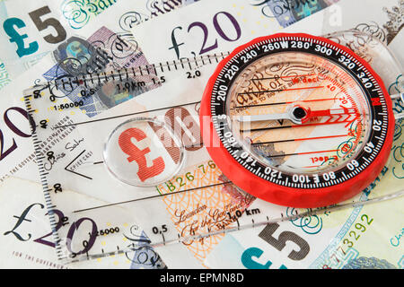 Compass focus on sterling money pound notes to illustrate direction of British economy after Brexit and financial growth concept. England UK Britain Stock Photo