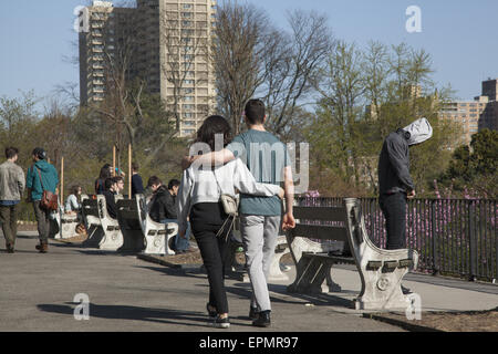 Young couple walk arm in arm at the Brooklyn Botanic Garden in the spring time in Brooklyn, NY. Stock Photo