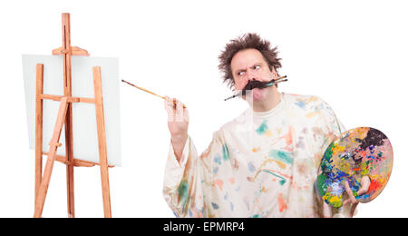 Concentrated painter paints on canvas Stock Photo