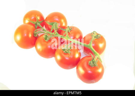 Eight small red tomatoes, in a cluster. Isolated on white background Stock Photo