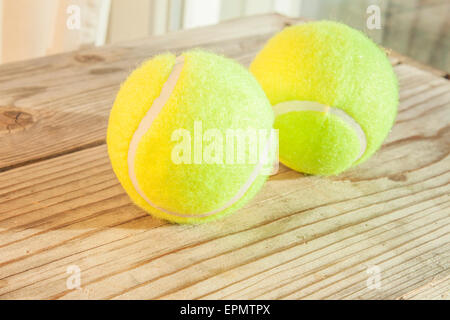 Neon green tennis balls, on wooden background Stock Photo