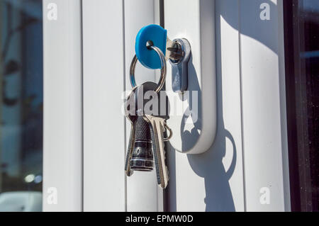 Keys in a door lock on a sunny day Stock Photo