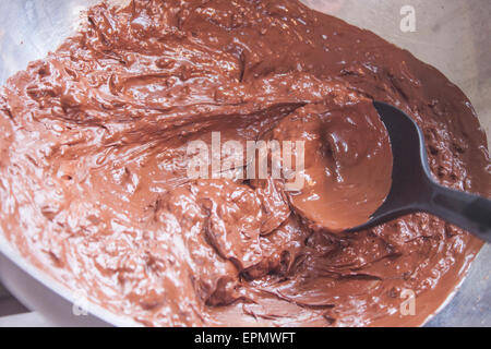 Melted, brown, temperate chocolate, in a aluminium bowl Stock Photo