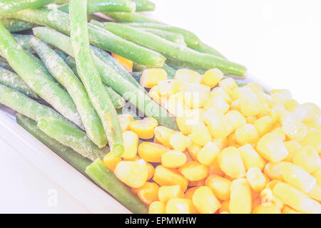 Green beans and yellow corn, isolated on white background Stock Photo