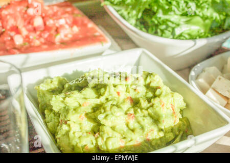 Green guacamole and red salsa, at a mexican party Stock Photo