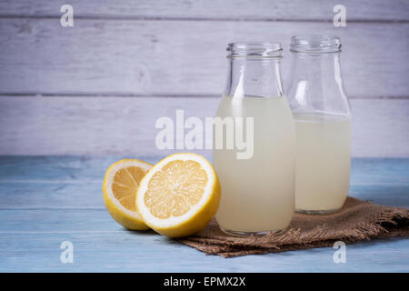 Traditional cloudy lemonade in glass bottles Stock Photo