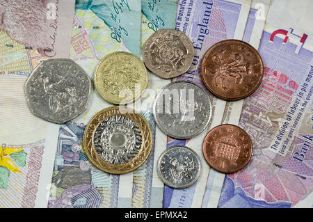 UK Currency Notes with One of Each UK Coin Stock Photo