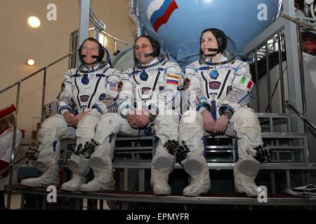 International Space Station Expedition 40 backup crew members NASA astronaut Terry Virts (left), Soyuz commander Anton Shkaplerov and Samantha Cristoforetti of the European Space Agency (right) pose in front of a Soyuz simulator at the Gagarin Cosmonaut Training Center May 5, 2015 in Star City, Russia. Stock Photo