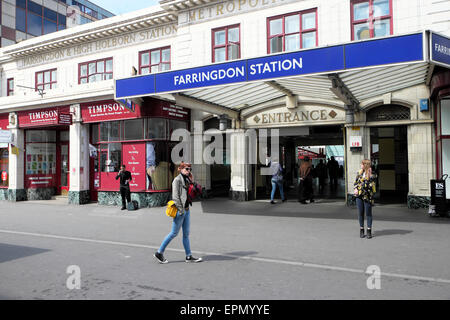 Woman on mobile phone outside exterior old Farringdon Station entrance Cowcross Street in London UK  KATHY DEWITT Stock Photo