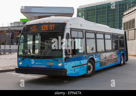 An M15 NovaBus LFS Articulated bus waits to depart for 125th Street from South Ferry in New York City. Stock Photo