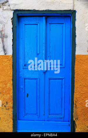 Blue door on yellow wall Stock Photo