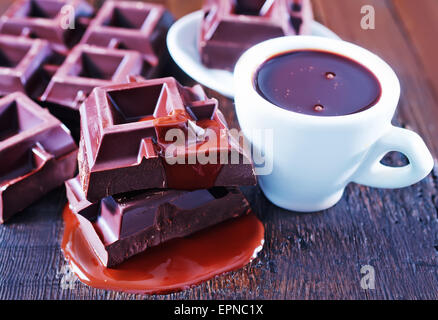 chocolate in cup and on the wooden table Stock Photo